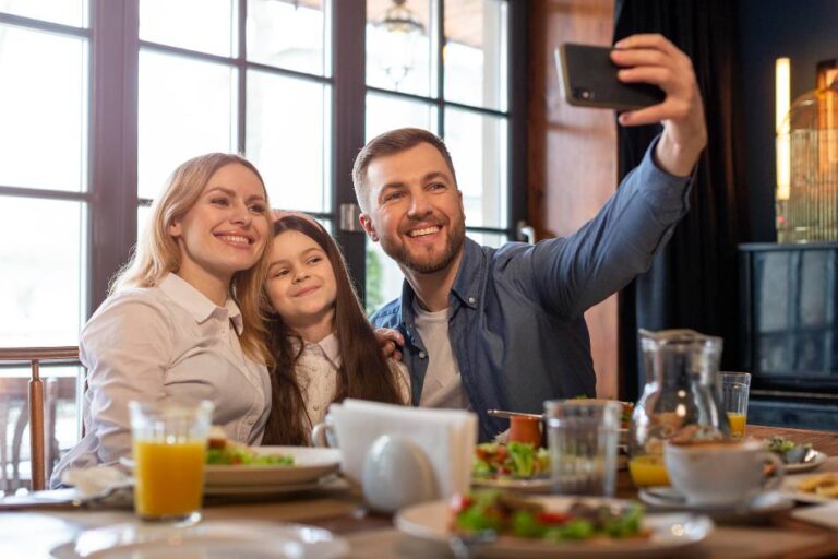 Família feliz tirando selfie em um restaurante